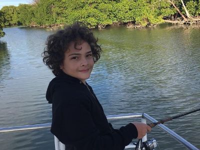 Hayden Rolence is holding the fishing rod as he looks for the picture.